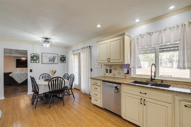 kitchen featuring cream cabinetry, dishwasher, sink, and a wealth of natural light