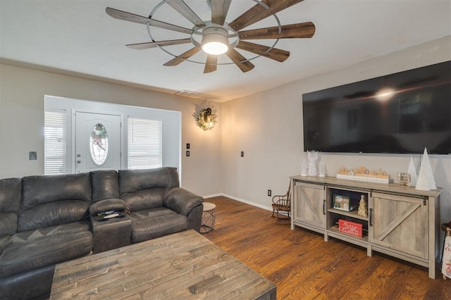 living room with dark hardwood / wood-style flooring and ceiling fan