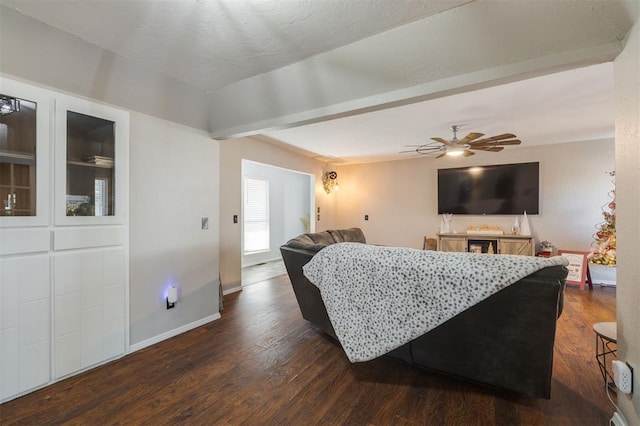 living room featuring ceiling fan and dark wood-type flooring