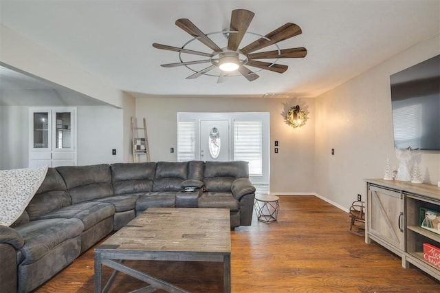 living room featuring ceiling fan and dark hardwood / wood-style flooring