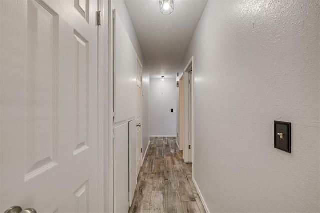 hallway with light hardwood / wood-style flooring