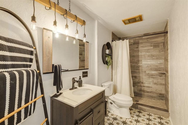 bathroom featuring toilet, vanity, and walk in shower