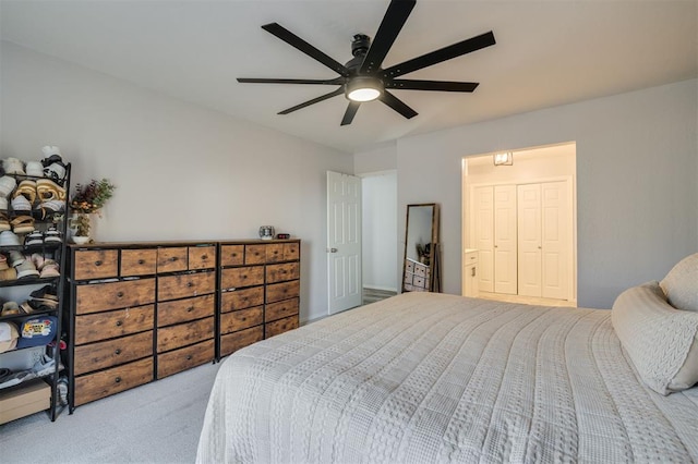 carpeted bedroom featuring ceiling fan and a closet