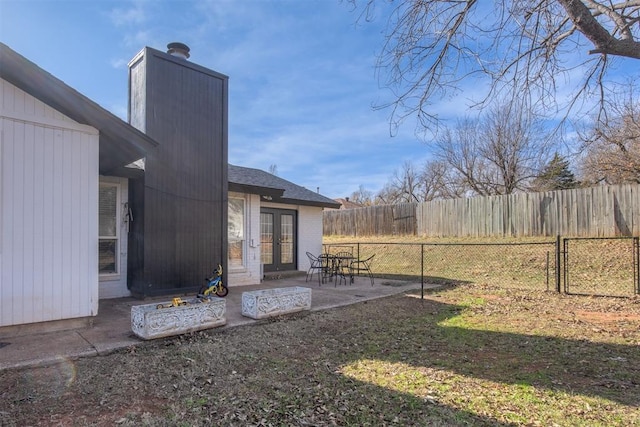 view of yard featuring a patio area and french doors