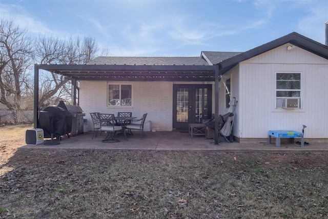 rear view of house featuring cooling unit, a patio, and french doors