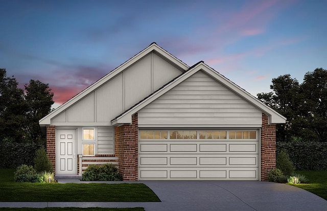 view of front of home with a garage and a yard