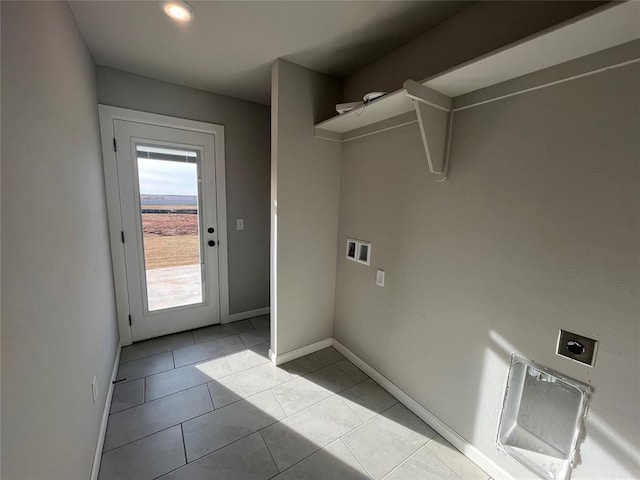 laundry area with electric dryer hookup, hookup for a washing machine, and light tile patterned floors