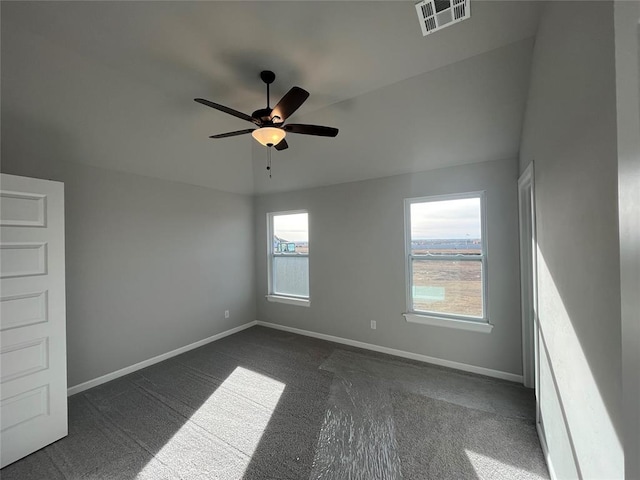 empty room featuring dark colored carpet and ceiling fan