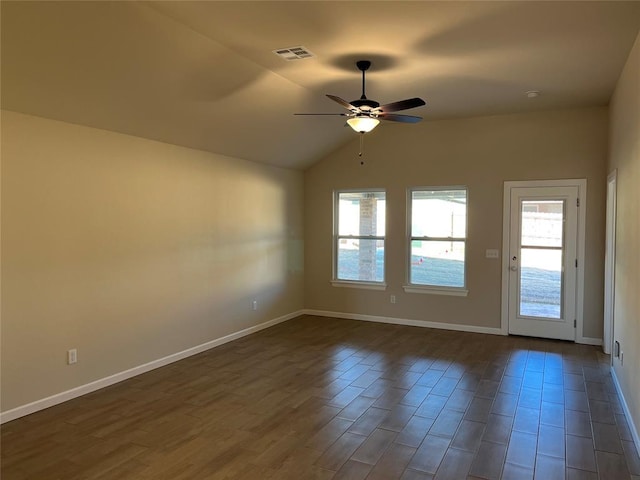 empty room with lofted ceiling, ceiling fan, and dark hardwood / wood-style floors