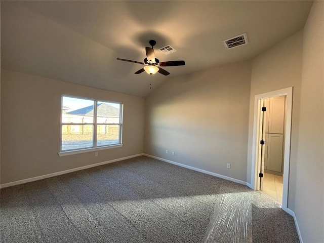 empty room with carpet, vaulted ceiling, and ceiling fan