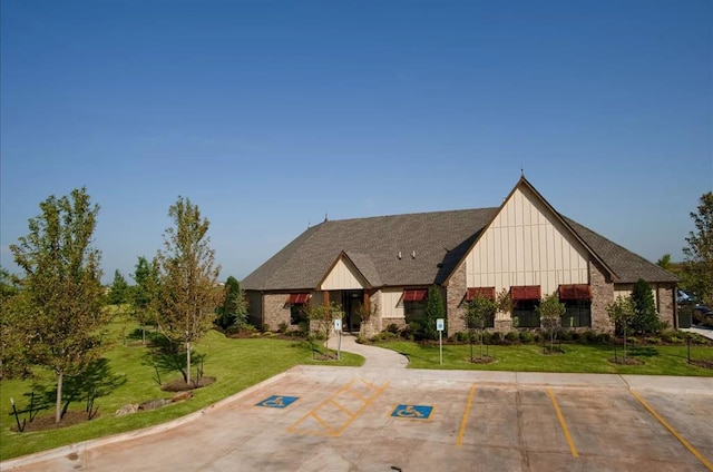 view of front of property featuring board and batten siding, uncovered parking, and a front lawn