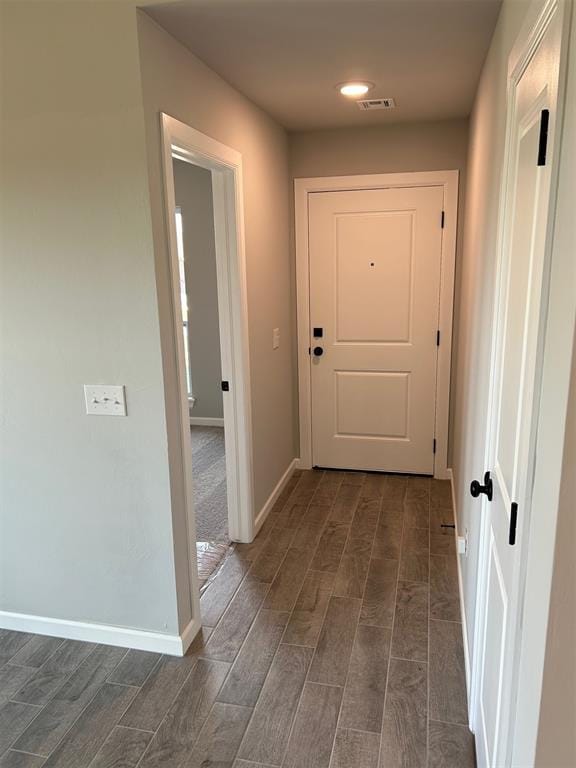 hall with dark wood-type flooring