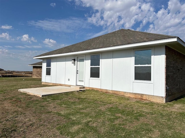 rear view of property with a patio area and a yard