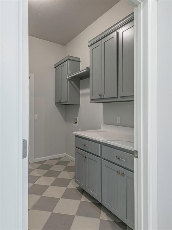 laundry area with hookup for a washing machine and cabinets