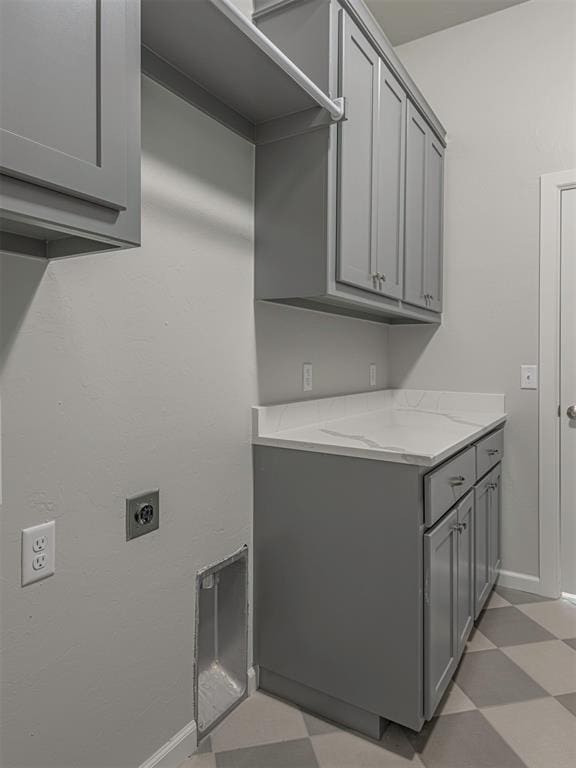 clothes washing area with hookup for an electric dryer and cabinets