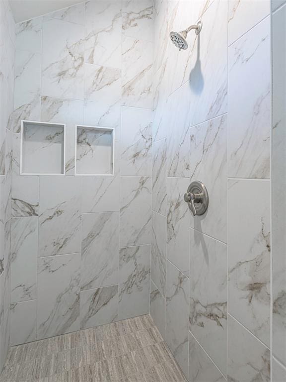 bathroom with tiled shower