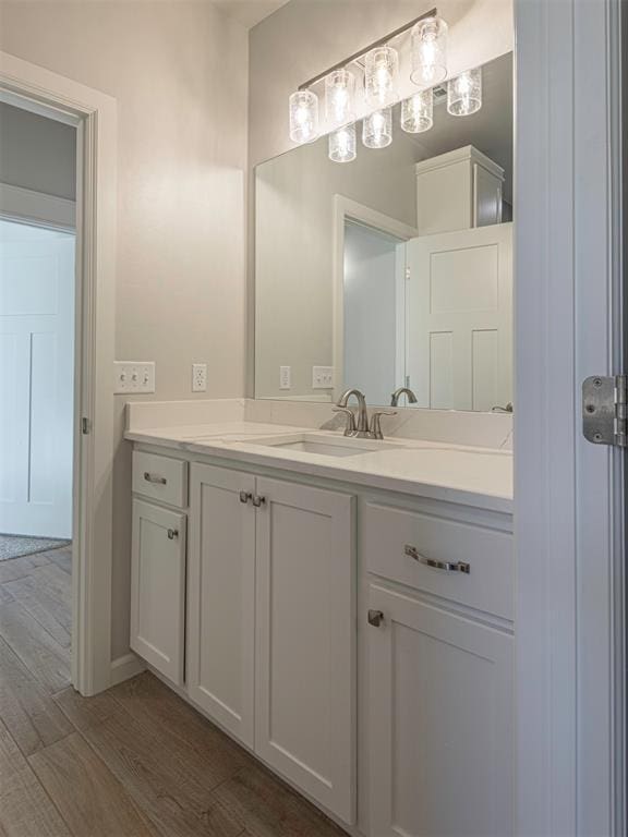 bathroom with hardwood / wood-style floors and vanity