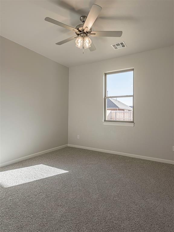 spare room featuring carpet flooring and ceiling fan