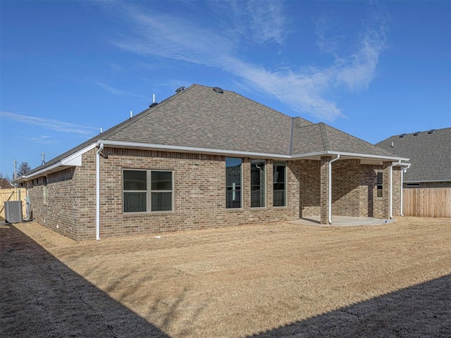 rear view of house with a patio area and central AC