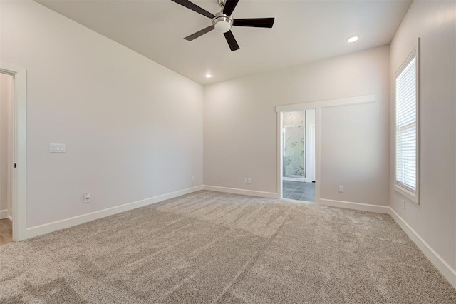 carpeted empty room with ceiling fan and a healthy amount of sunlight