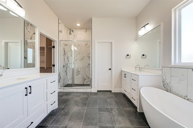 bathroom with vanity and separate shower and tub