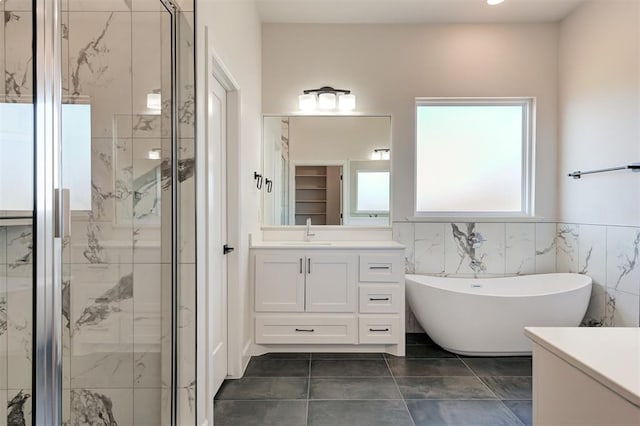 bathroom featuring vanity, independent shower and bath, tile patterned flooring, and tile walls