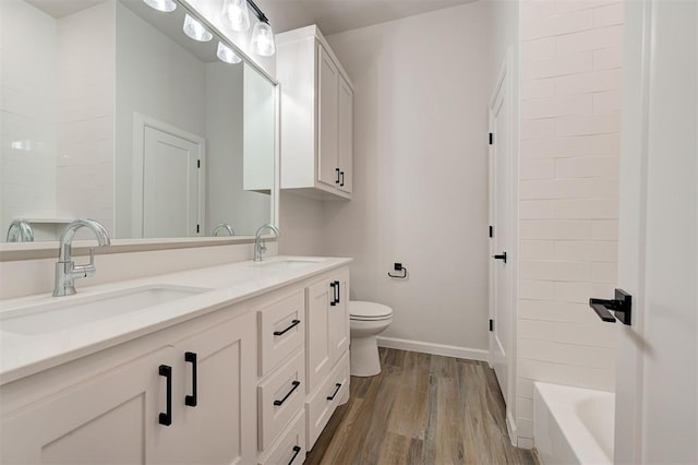 bathroom featuring vanity, hardwood / wood-style flooring, and toilet