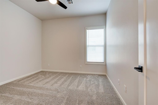 carpeted spare room with ceiling fan