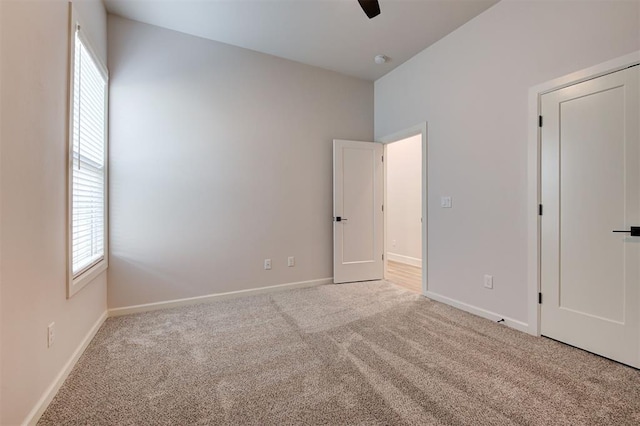 unfurnished bedroom featuring ceiling fan and light carpet