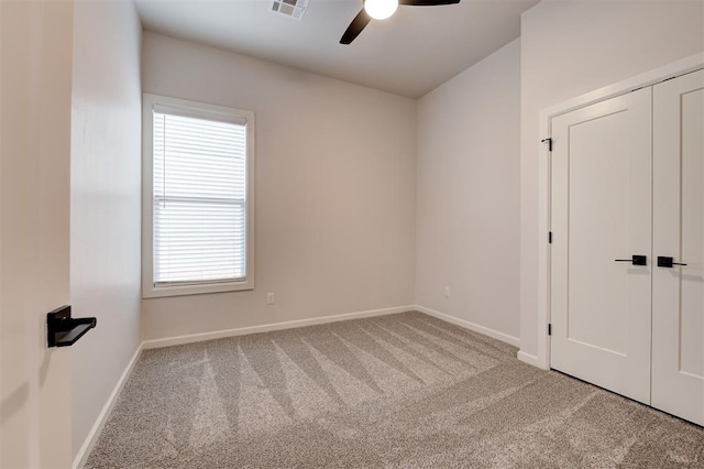 carpeted empty room with ceiling fan