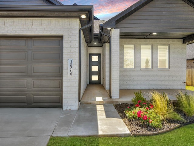 exterior entry at dusk with a garage