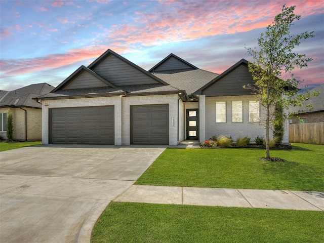 view of front facade featuring a garage and a lawn