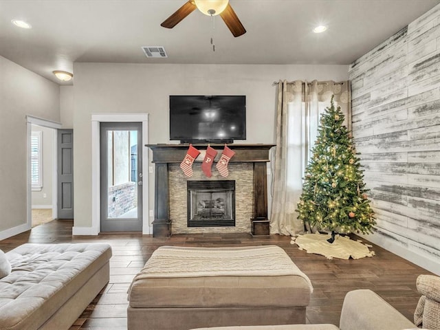 living room featuring ceiling fan, a fireplace, and hardwood / wood-style floors