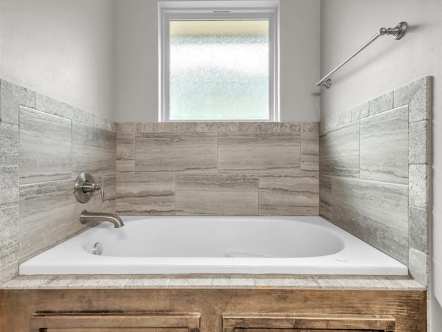 bathroom with tiled bath