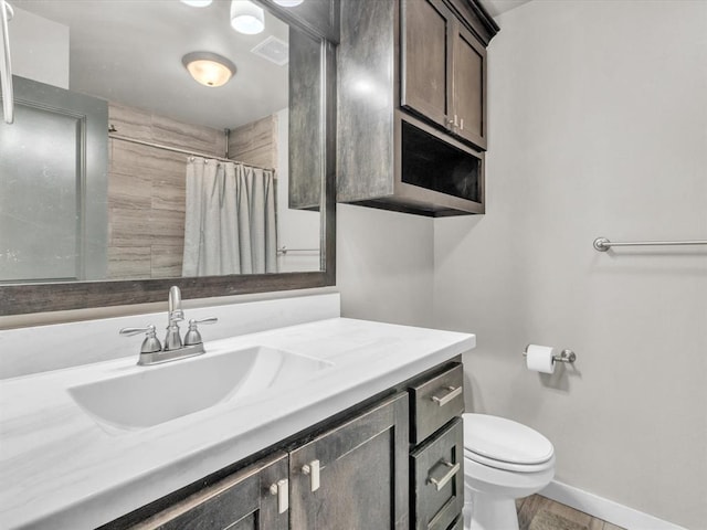 bathroom with a shower with shower curtain, vanity, toilet, and hardwood / wood-style flooring