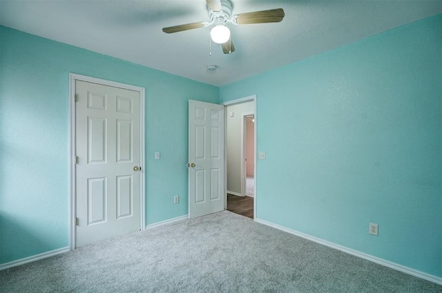 unfurnished bedroom featuring ceiling fan and carpet flooring