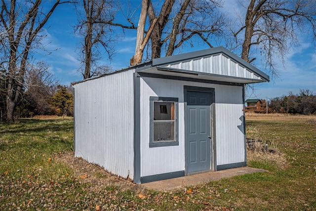 view of outbuilding featuring a lawn