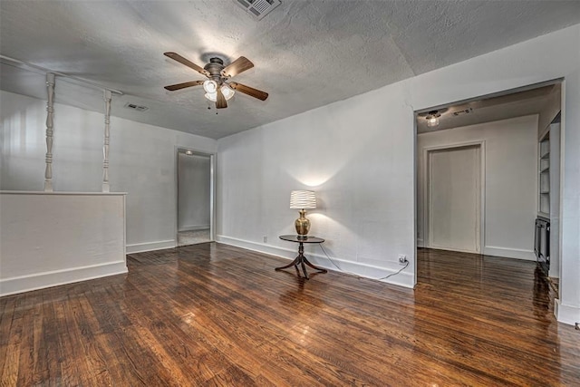 unfurnished room with a textured ceiling, dark hardwood / wood-style floors, and ceiling fan