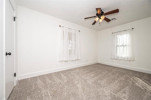 unfurnished room featuring ceiling fan and carpet floors