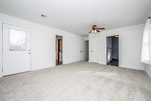 unfurnished bedroom with dark colored carpet and ceiling fan