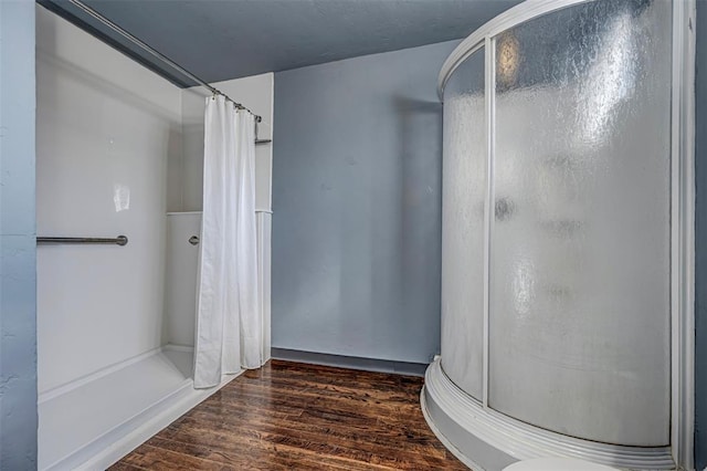 bathroom with curtained shower and hardwood / wood-style floors