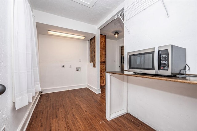 kitchen with hardwood / wood-style floors and a textured ceiling