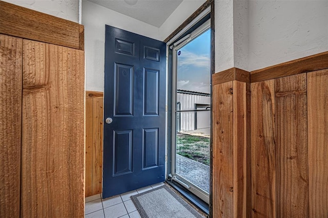 doorway to outside with light tile patterned floors