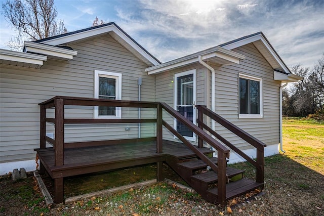 view of exterior entry featuring a deck