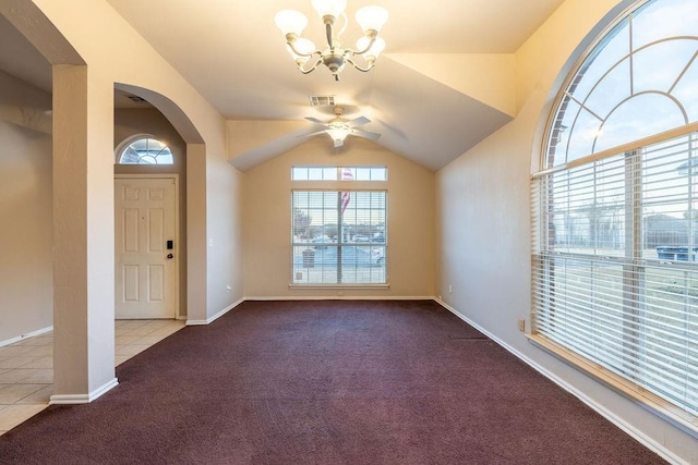 carpeted foyer with ceiling fan with notable chandelier