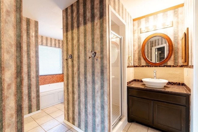 bathroom with tile patterned flooring, vanity, and separate shower and tub