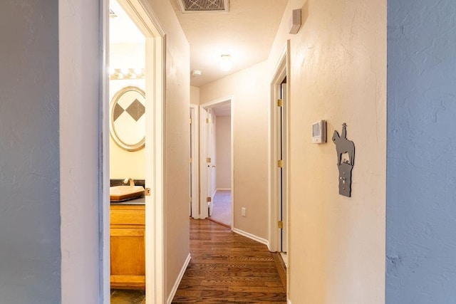 corridor featuring dark wood-type flooring