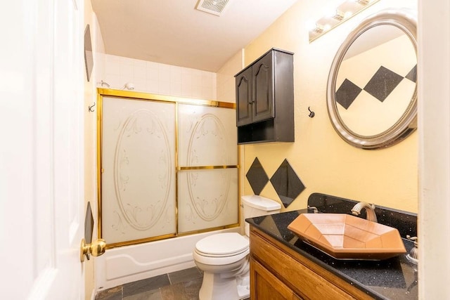 full bathroom featuring vanity, toilet, and enclosed tub / shower combo