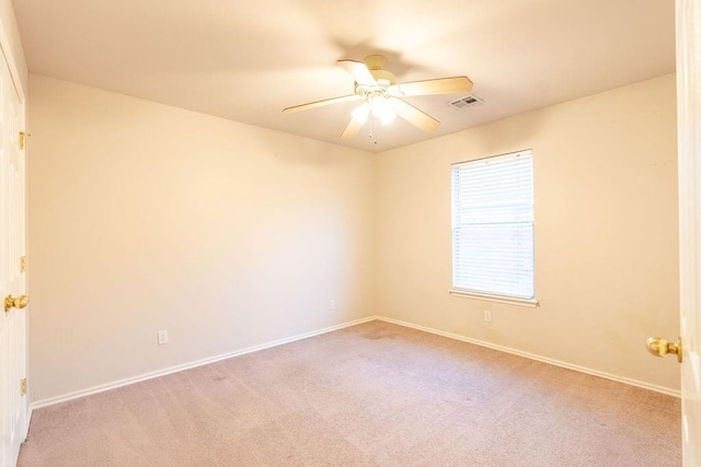 empty room featuring light carpet and ceiling fan