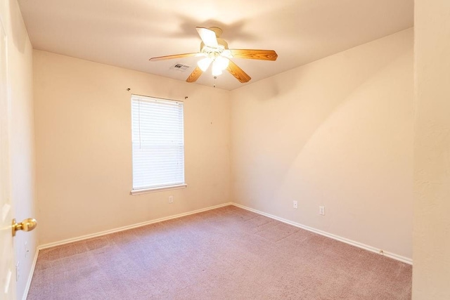 unfurnished room featuring light carpet and ceiling fan